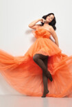 Woman wears Juzo Inspiration in cocoa and an orange tulle dress