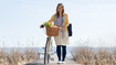 Woman with compression stockings is pushing her bike.