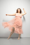 Woman wears Juzo Inspiration in sesame and a pink tulle dress